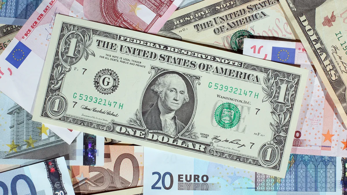 Image shows U.S. dollar bills and Euros.