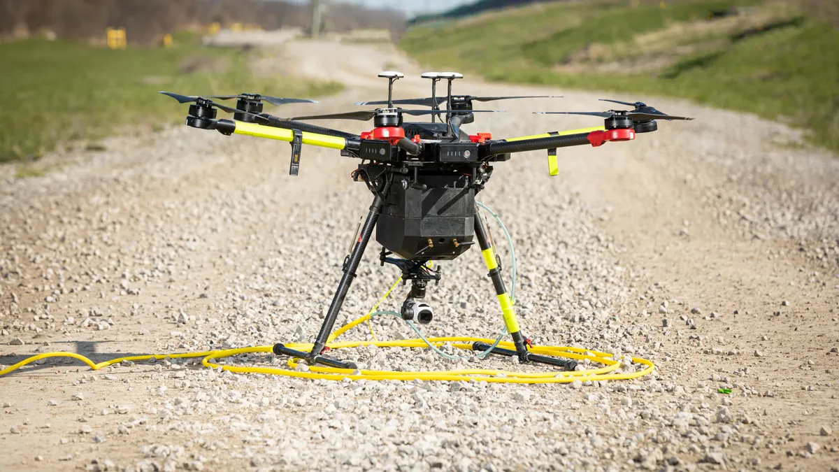 A drone sitting on a gravel road