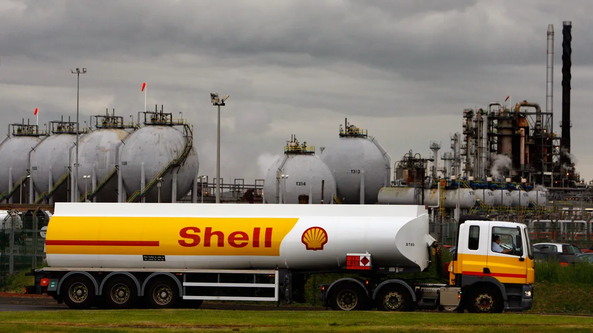 A Shell tanker is seen in front of an oil station.