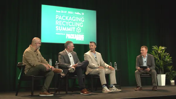 Four people sit in chairs on a stage in front of a green background that says Packaging Recycling Summit.