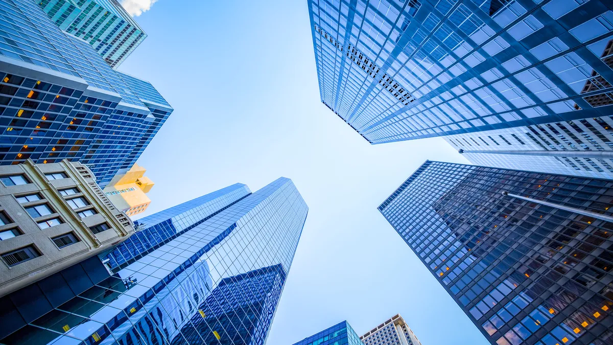 Looking upward at skyscrapers.