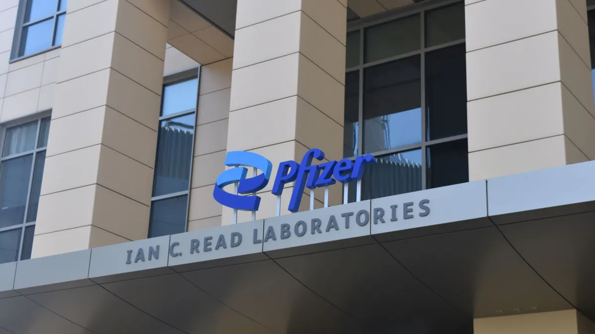 A Pfizer logo sits atop the entrance of the company's Ian C. Read Laboratories in Cambridge, Massachusetts, on Sept. 5, 2024.
