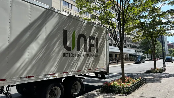 UNFI truck parked on side of street