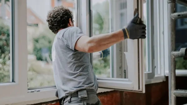 Worker installing a window.