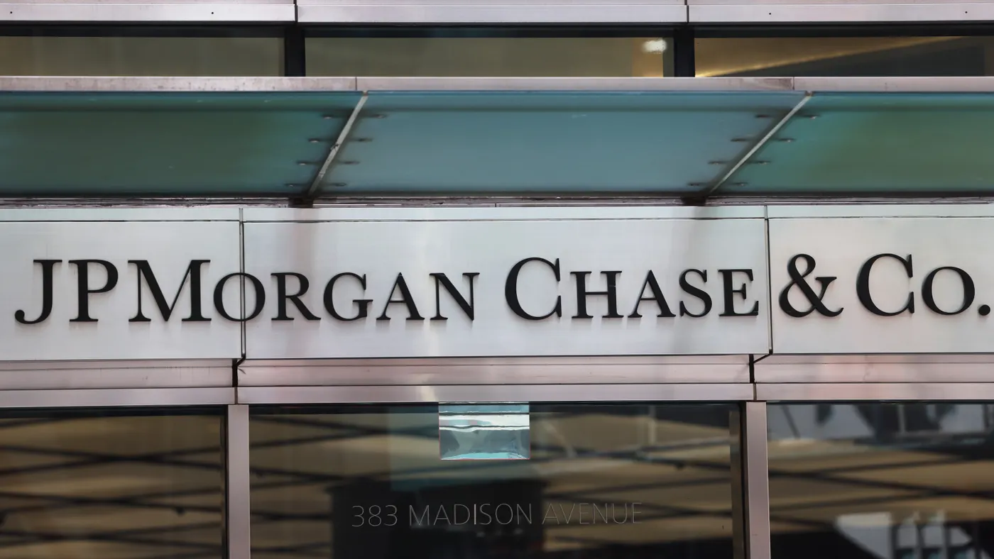 A logo reading "JPMorgan Chase & Co." hangs over a set of doors