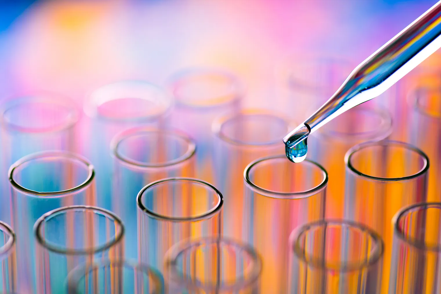 Close-Up Of Pipette Dripping Chemical In Test Tube At Laboratory