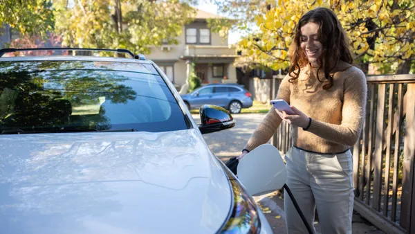 Woman pumping gas in car