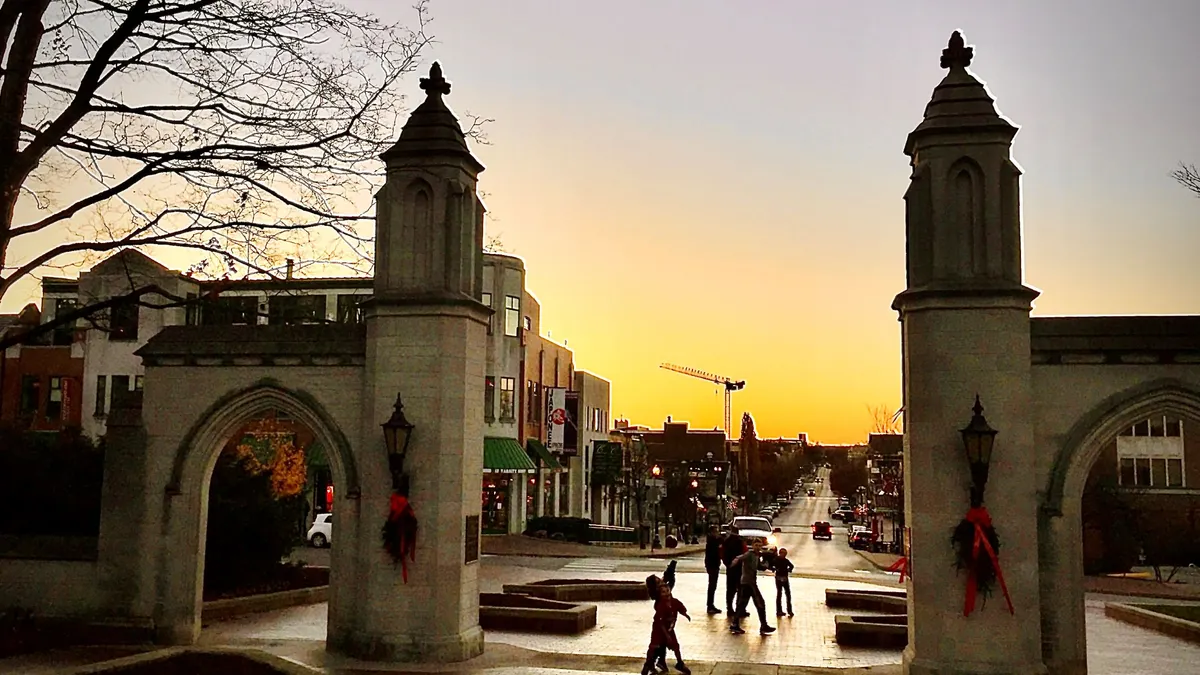 The gates of Indiana University's flagship campus at sunset in Bloomington, Ind.