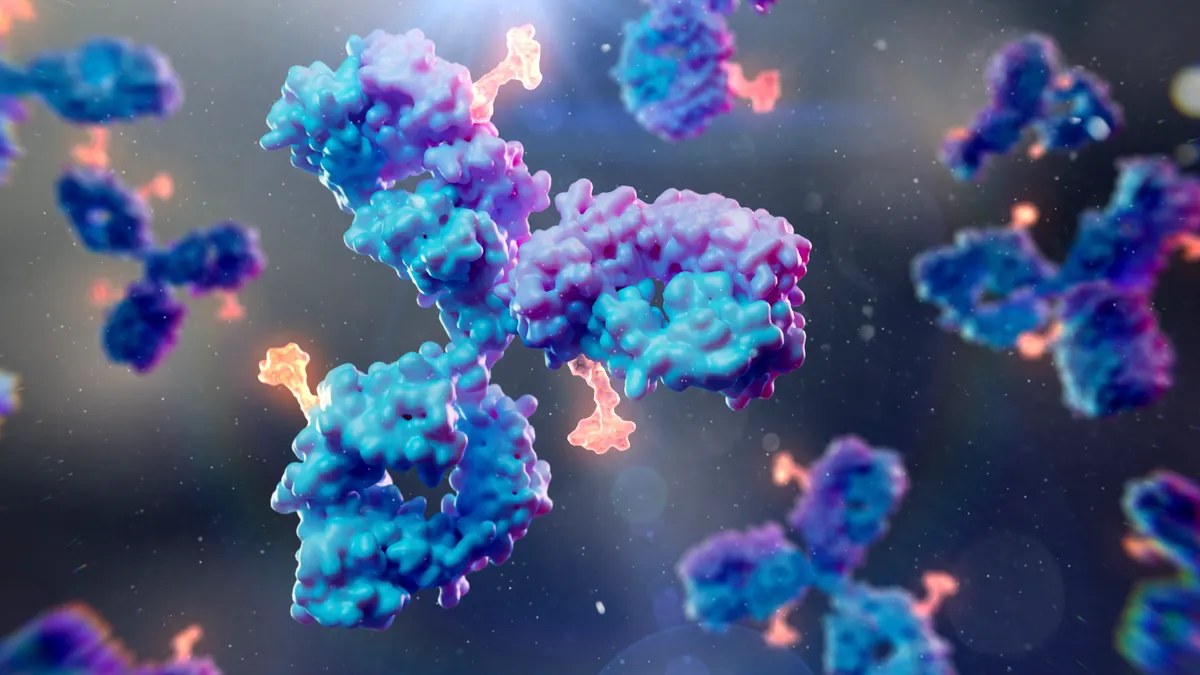 Illustration of an antibody-drug conjugate with a blue and purple antibody linked to an orange cytotoxic payload.