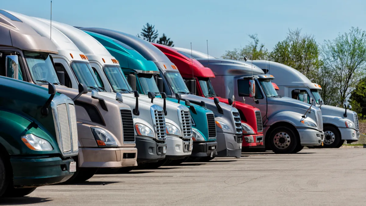 Group of multi-colored trucks parked at a truck stop in Missouri.