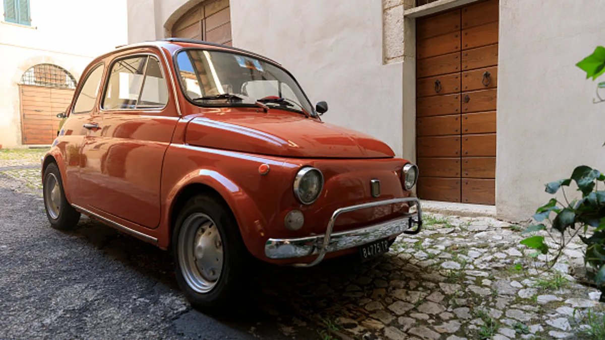 Fiat 500 parked in street in Amelia, Italy in August 2020.