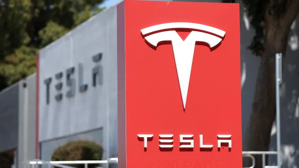 A sign is posted in front of a Tesla service center on April 20, 2022 in Fremont, California.