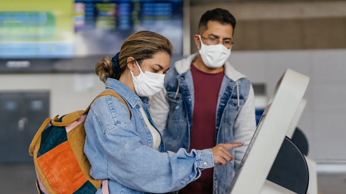 Couple at self-service airport check-in