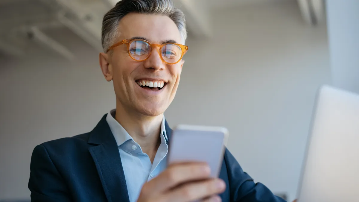 Smiling mature man using laptop