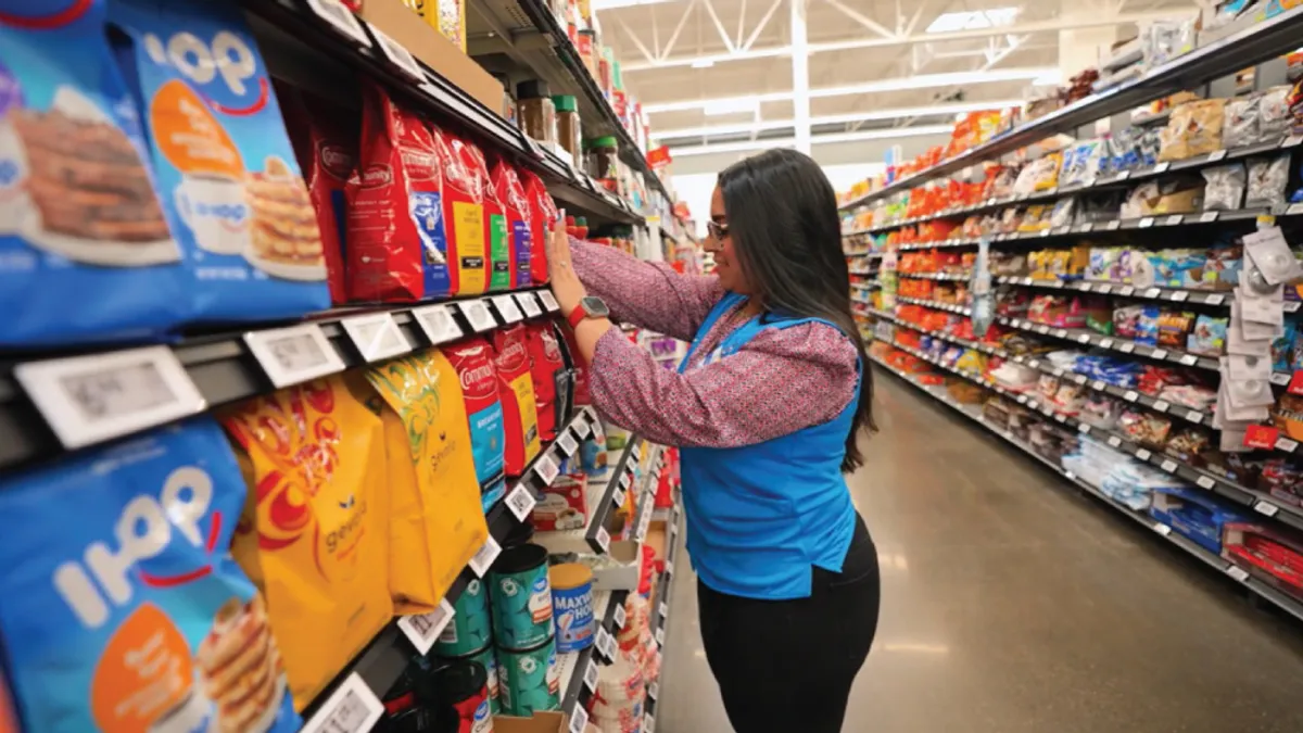 A person in a blue vest in a store