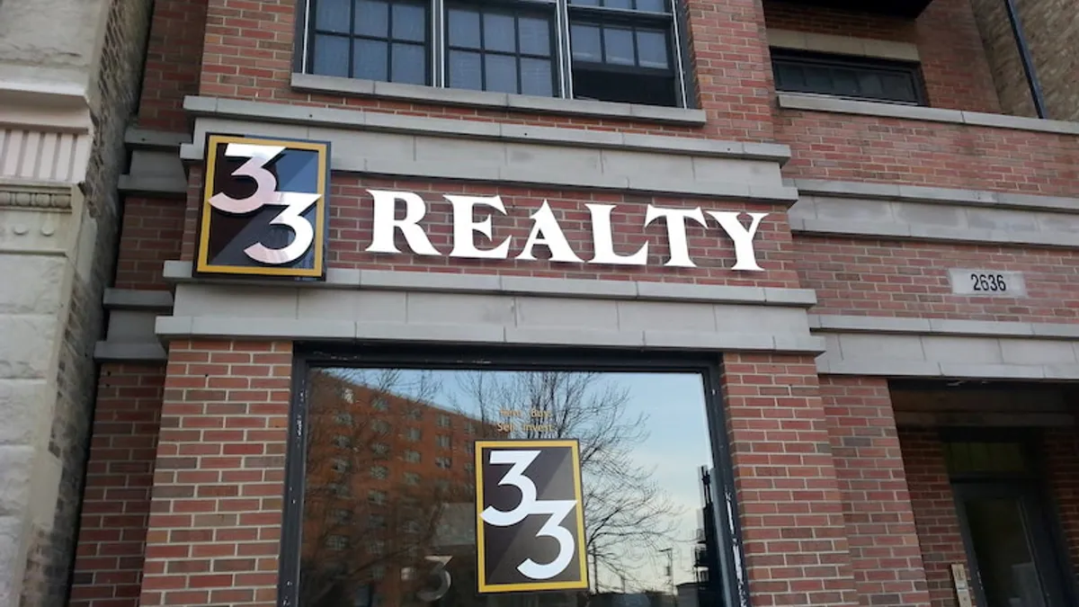 Brick building with 33 Realty sign