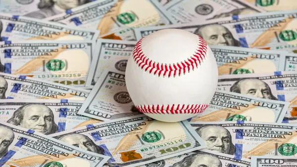 Baseball atop cash; sports betting conceptual image