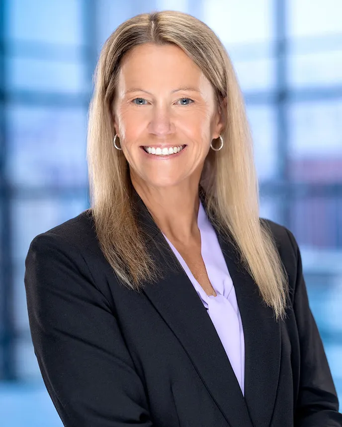 Headshot of a woman in business attire.