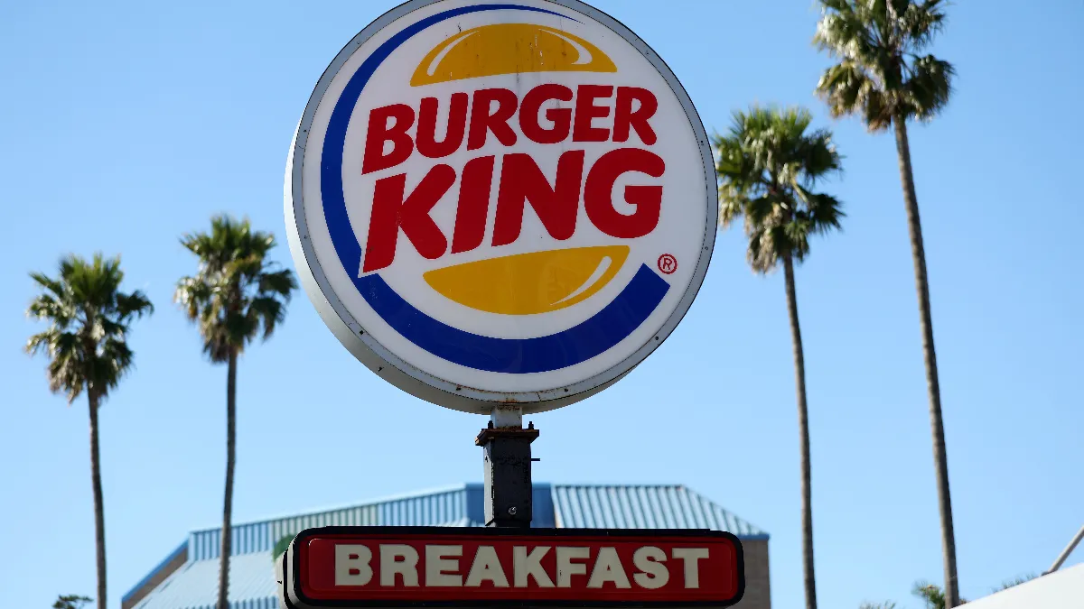 A round sign with the words Burger King on it.