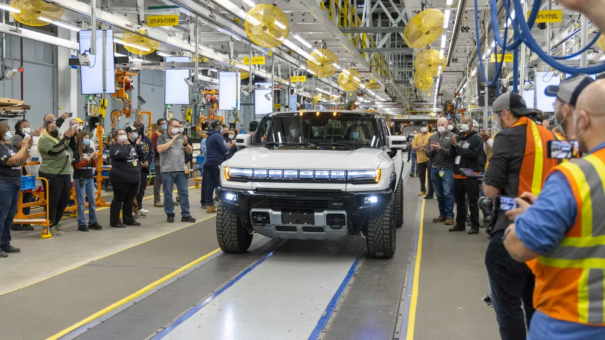 Workers assemble the GMC Hummer EV SUV.