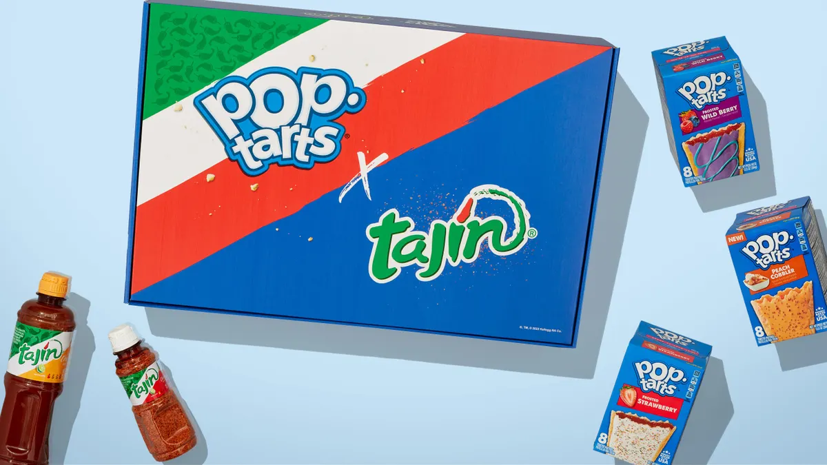 The box for the Pop-Tarts x Tajin kit, which is blue with green, white and red stripes on the upper left corner, sits between containers of Tajin spice and hot sauce and three boxes of Pop-Tarts.