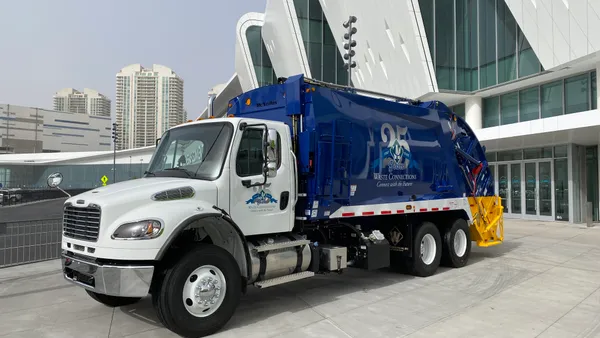 A Waste Connections collection truck is parked in front of the Las Vegas Convention Center