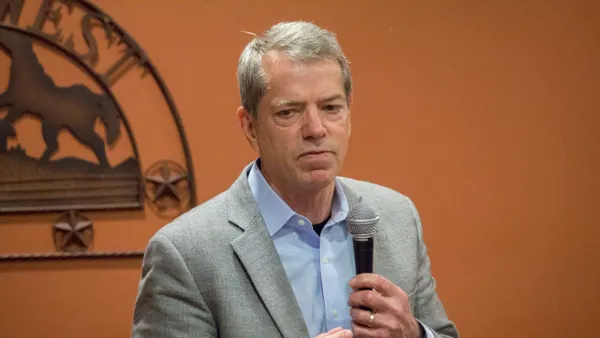 Jim Pillen speaks into a microphone.