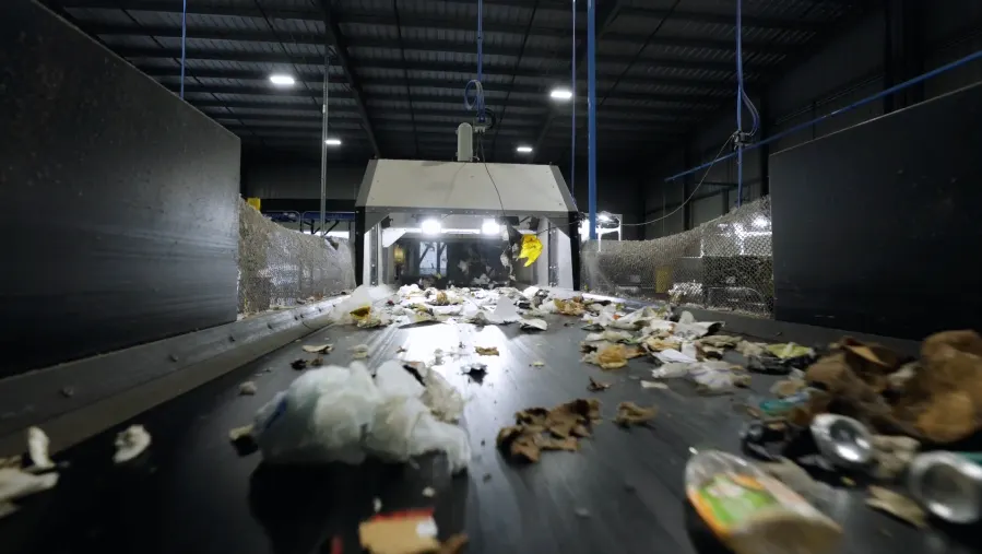 A close up image of recycled material moving along a belt