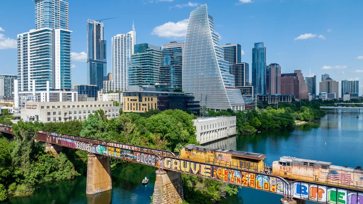 A freight train enters the downtown area of Austin, Texas.