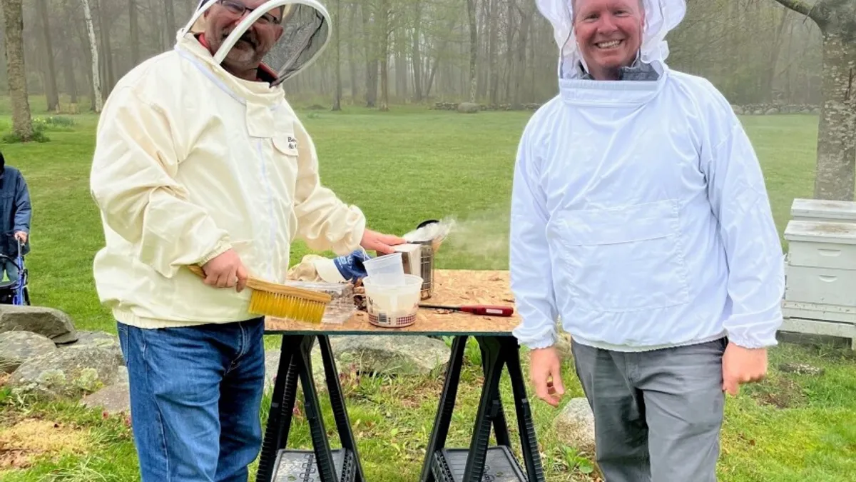 A picture shows Peter Murawski and Patrick Haddigan, two Turner Construction superintendents, in their beekeeping gear.