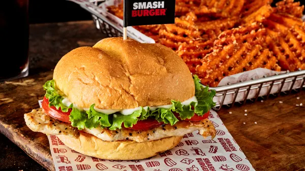 A photograph of a chicken sandwich, criss-cut fries and a soda.