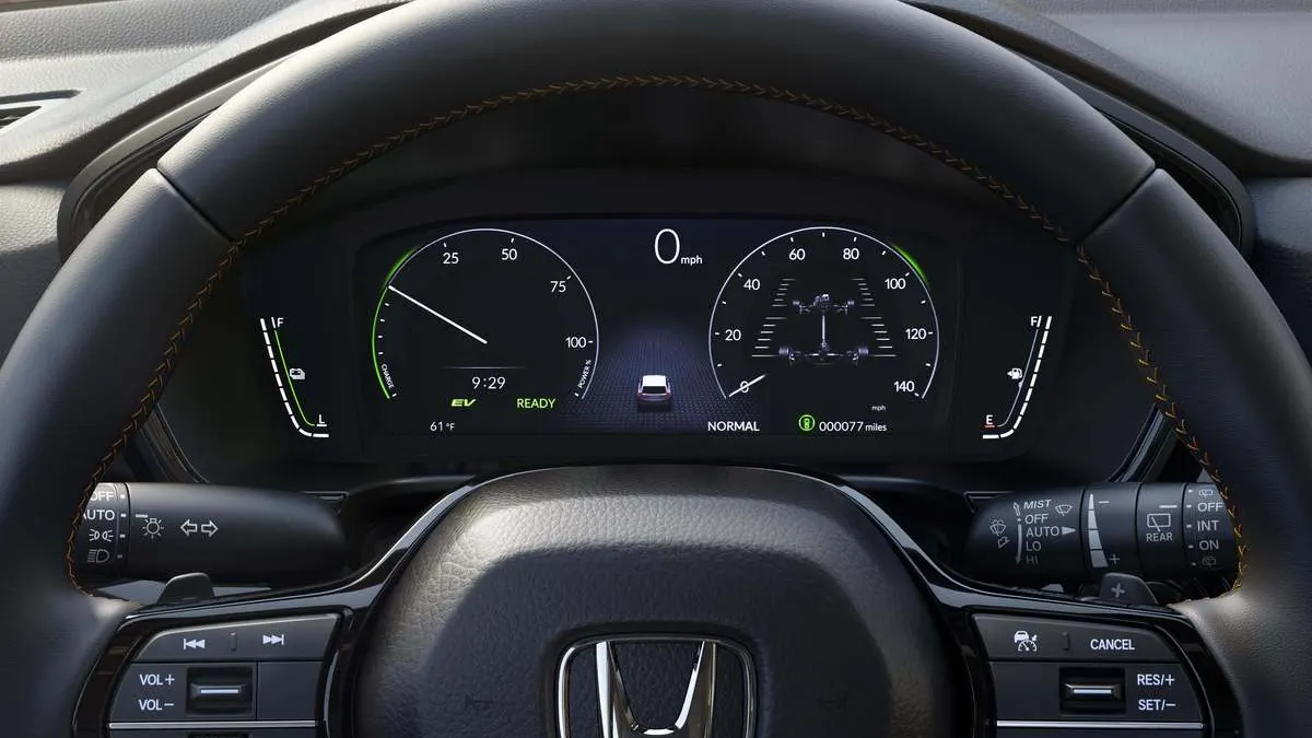 The steering wheel and instrument cluster in a 2026 Honda CR-V TrailSport Hybrid.