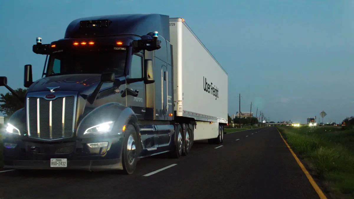 An Aurora truck with an Uber Freight trailer.