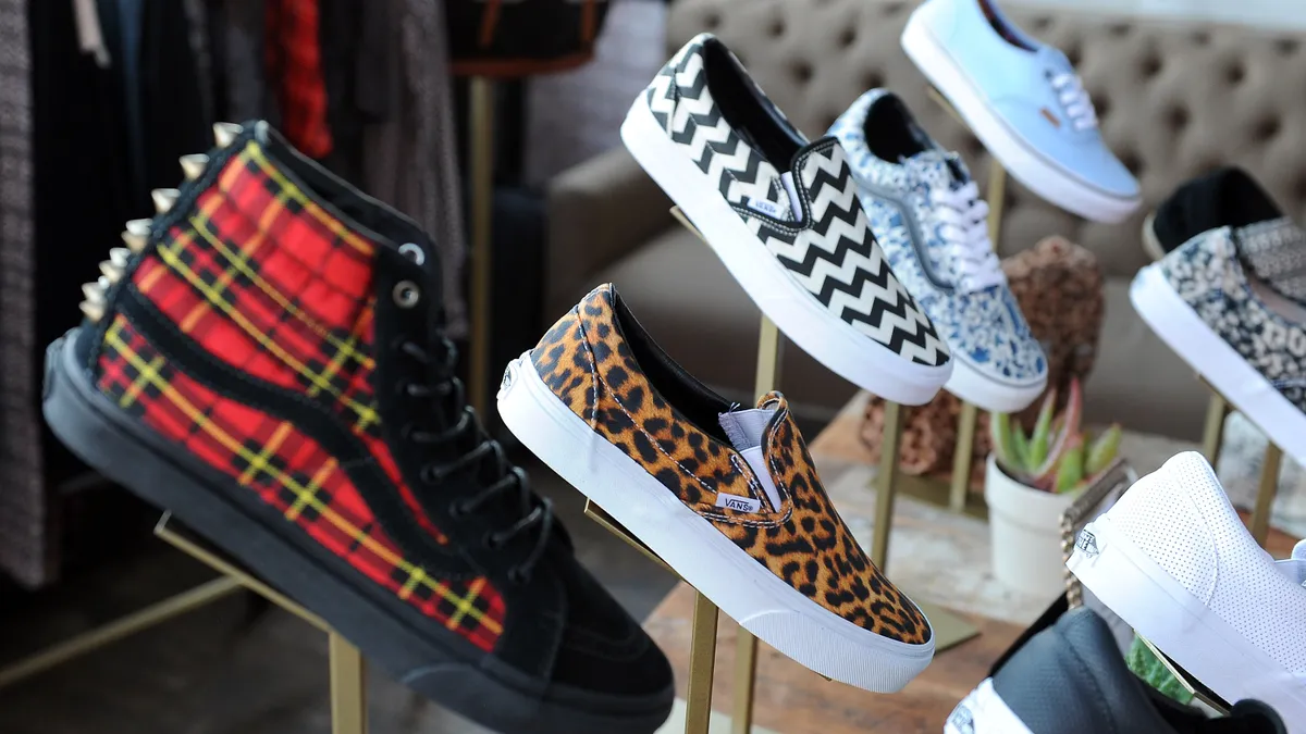 A group of women's shoes, Vans, are displayed in a store.