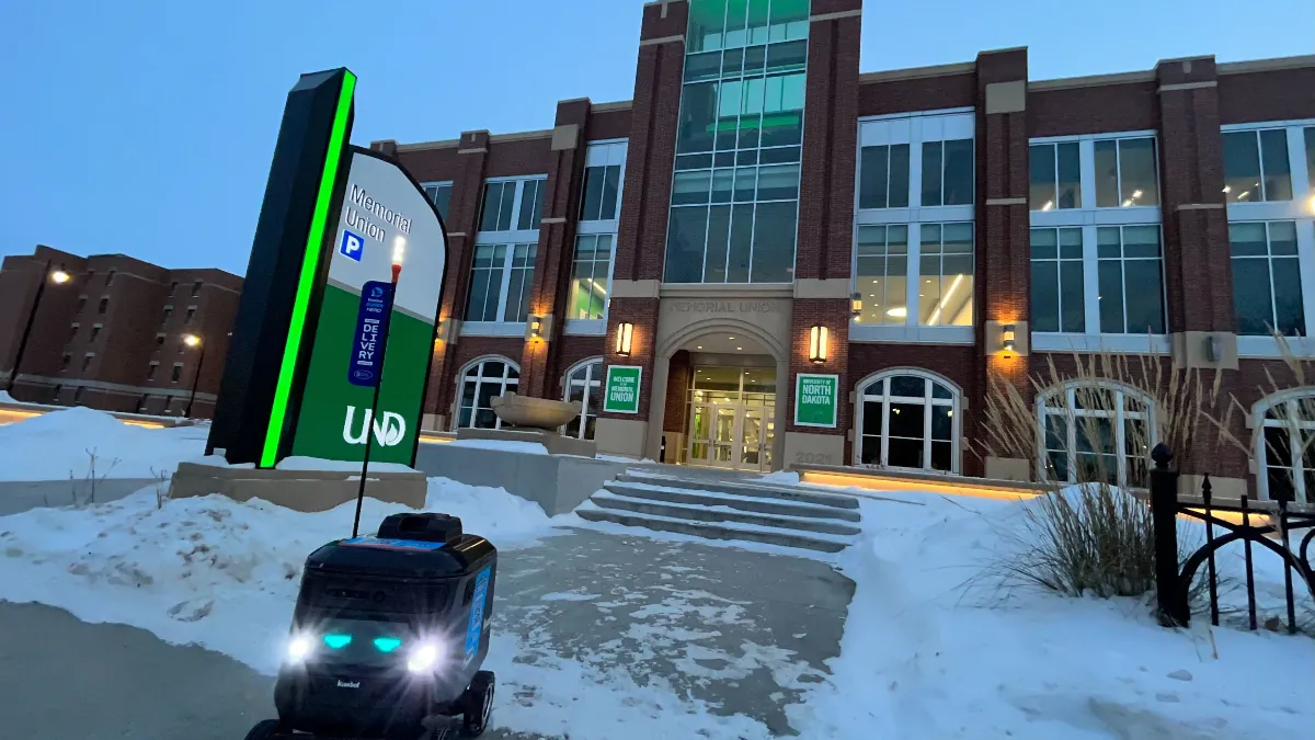 An image of a robot in front of a building at University of North Dakota.