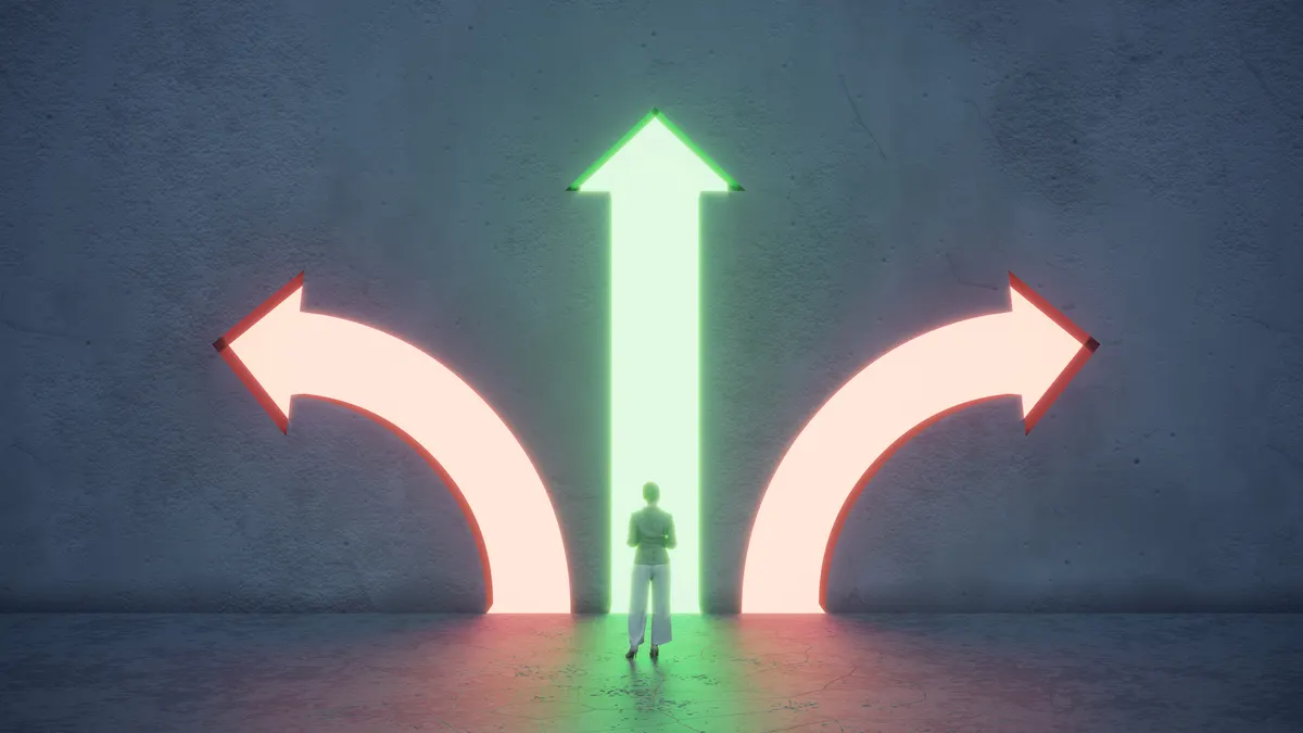 Woman standing in front of different colored arrow shaped portals.