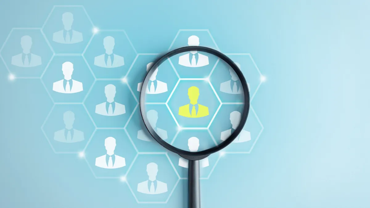 Human Resource Management, Magnifier glass focus to manager icon which is among staff icons for human development recruitment leadership and customer target group concept.