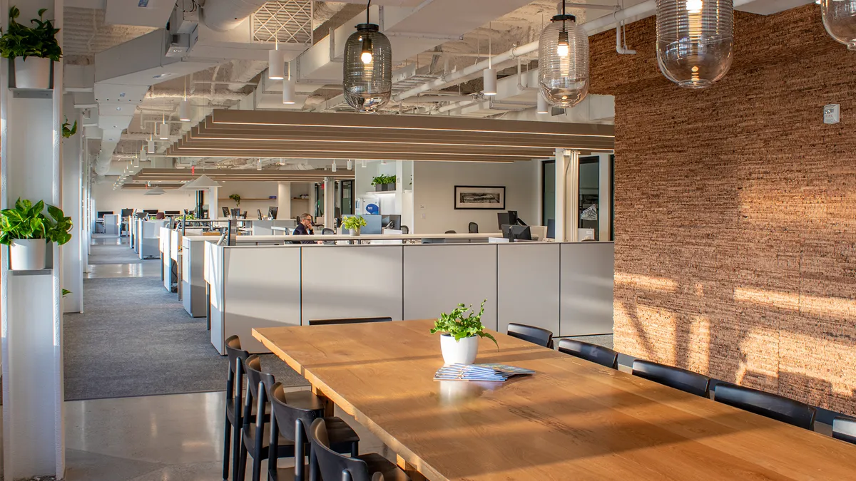 A modern office with exposed brick walls and an open floor plan