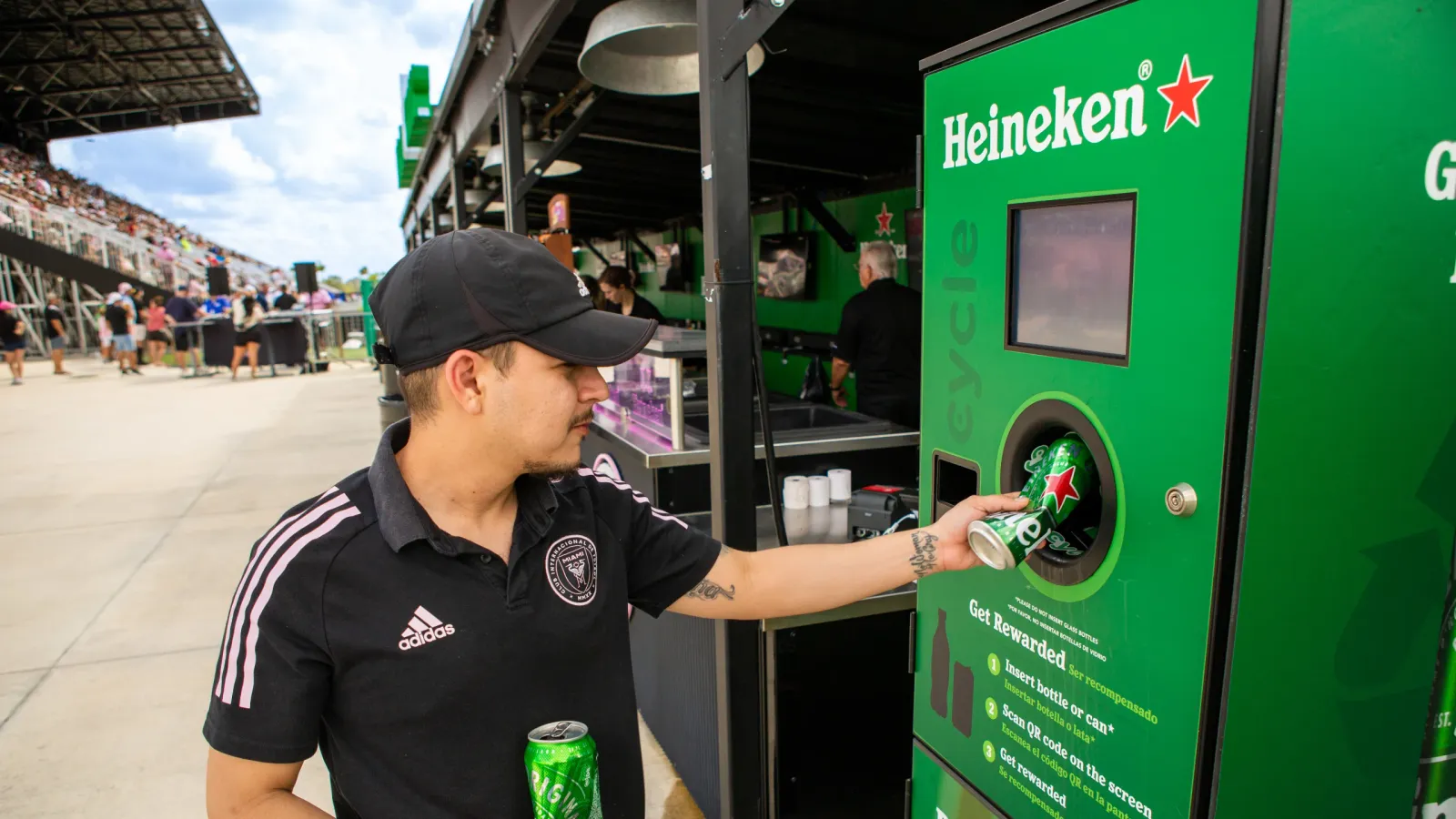 Man using reverse vending machine sports stadium