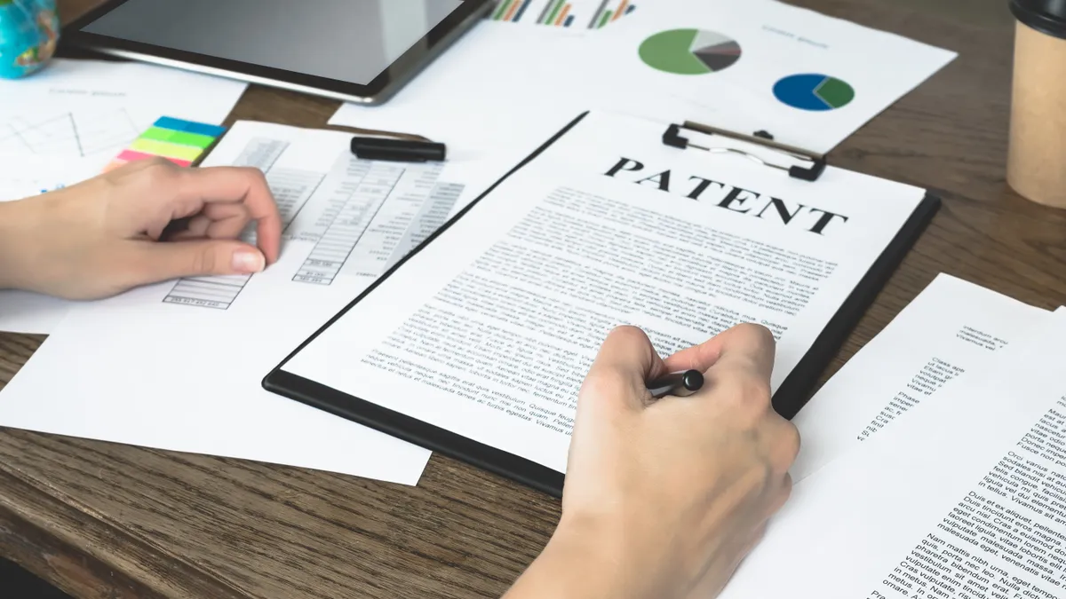 Business woman signs a patent.