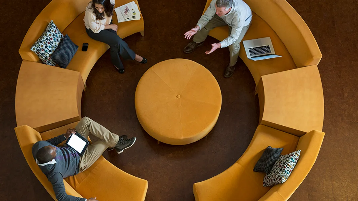 Aerial view of people sitting in a round sofa