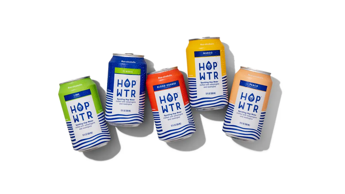 Cans of Hopwtr are next to each other against a white backdrop.