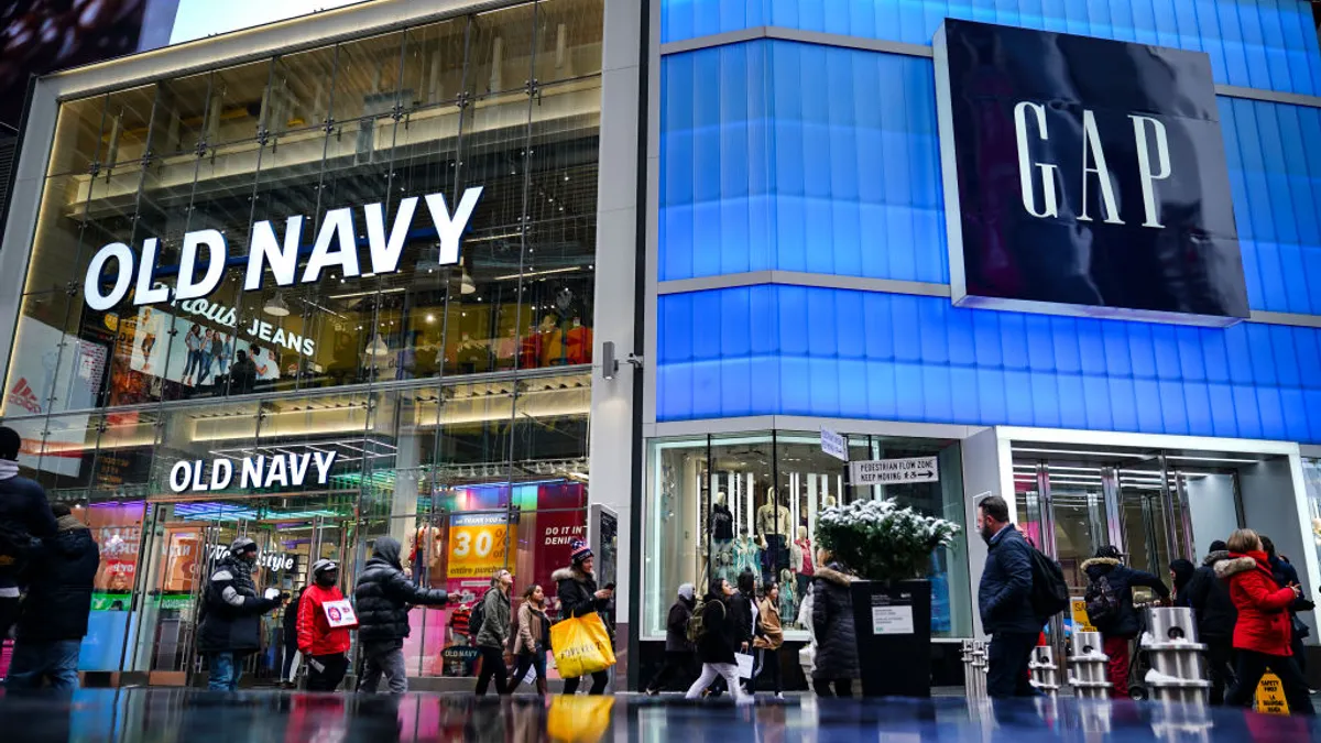 Pedestrians walk past Old Navy and GAP stores in Times Square