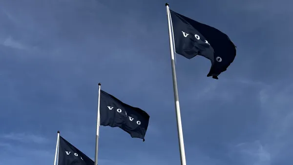 Blue Volvo flags wave in the sky.