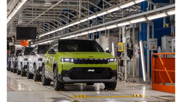 A light green Jeep Compass SUV on the assembly line at the Stellantis Melfi plant in Italy.