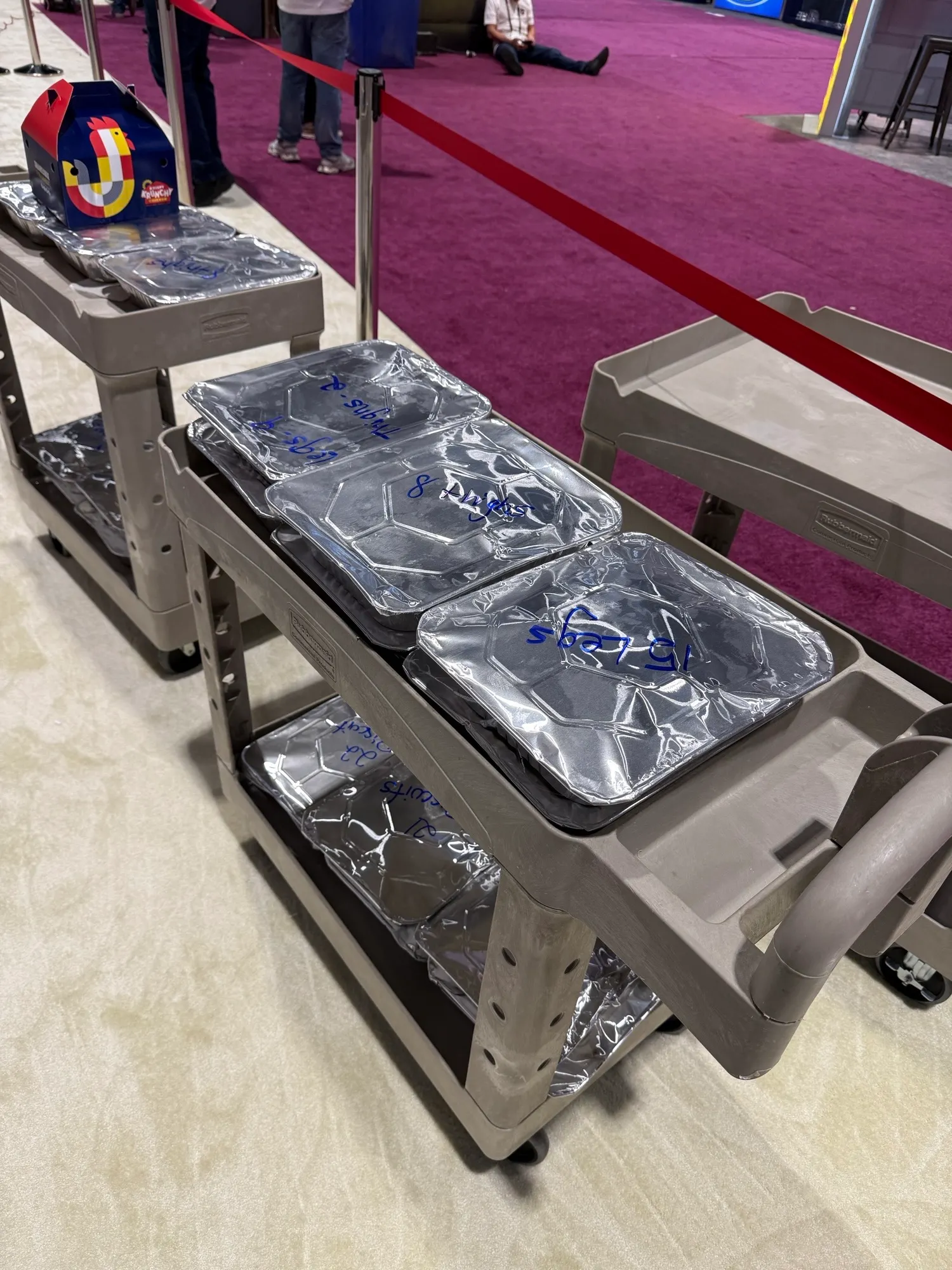 Closed containers of food on a trolly.