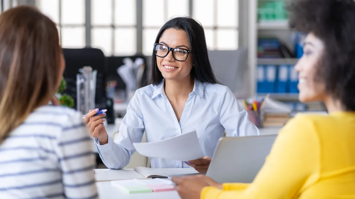 Female manager discussing business in creative office.