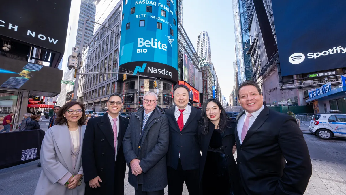 Leaders of Belite Bio posing in front of Belite Bio Nasdaq stock market listing