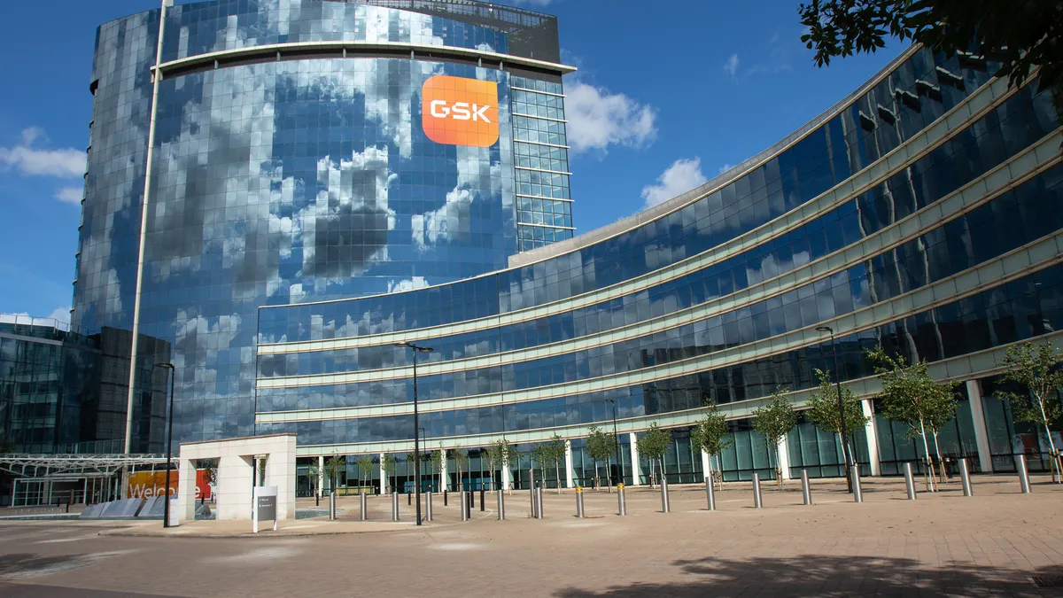 A photo of a building showing a GSK sign in London.