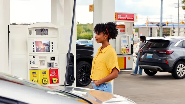 Person waiting at gas pump